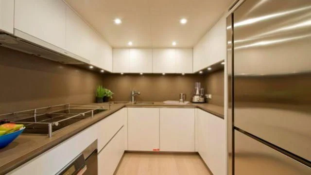 a kitchen with white cabinets aboard ELYSIUM Yacht for Sale