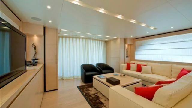 a living room with a couch and a tv aboard ELYSIUM Yacht for Sale