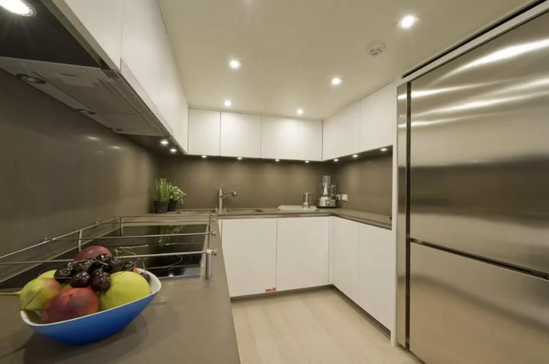 a kitchen with a bowl of fruit aboard ELYSIUM Yacht for Sale