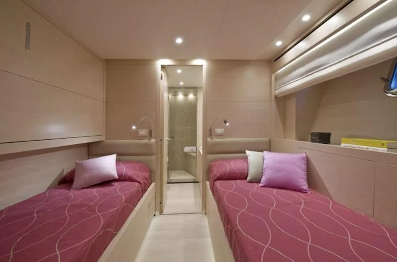 a room with pink beds aboard ELYSIUM Yacht for Sale