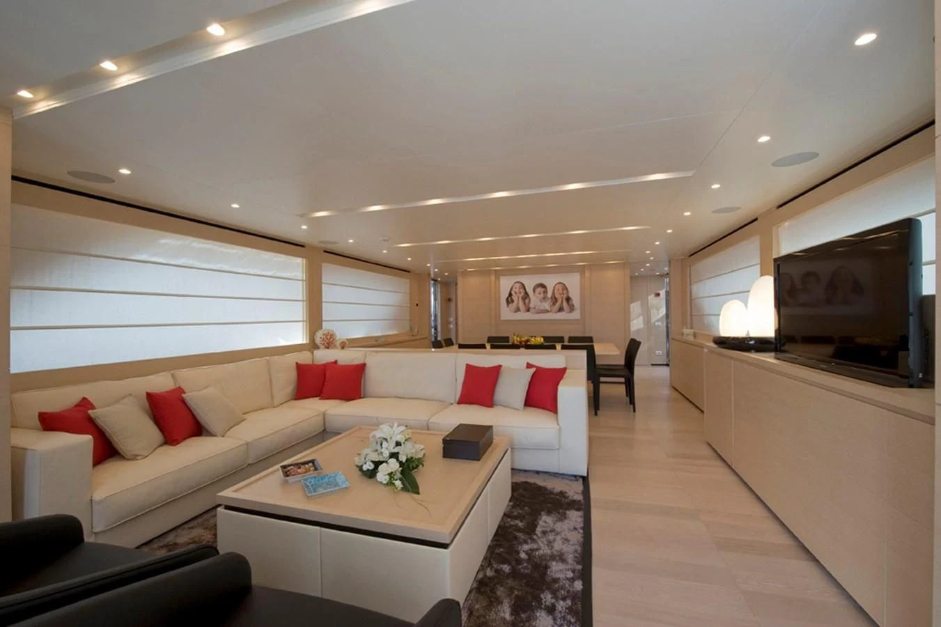 a living room with a white couch and a television aboard ELYSIUM Yacht for Sale