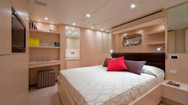 a bedroom with a bed and a shelf aboard ELYSIUM Yacht for Sale
