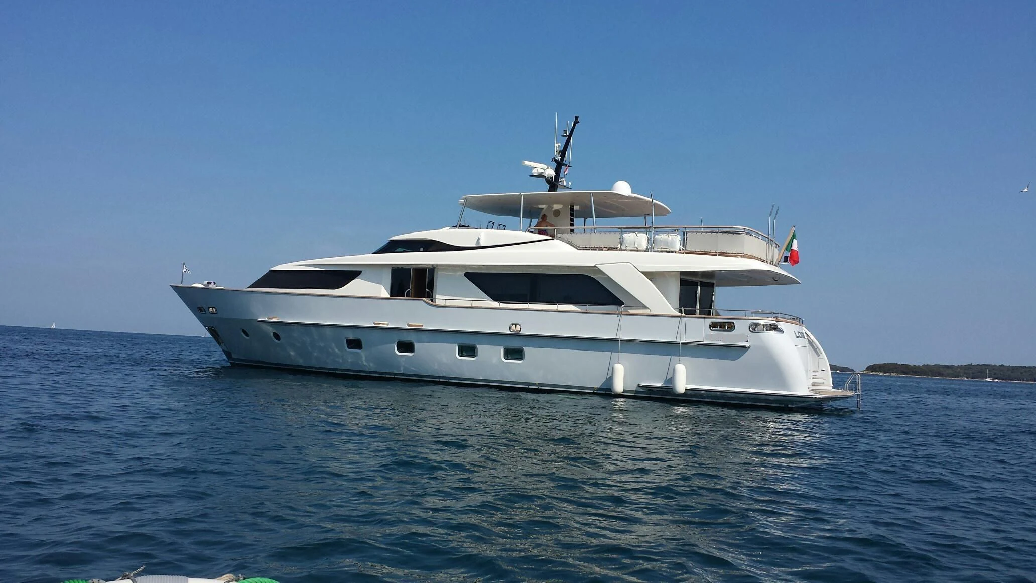 a white yacht on the water aboard ELYSIUM Yacht for Sale
