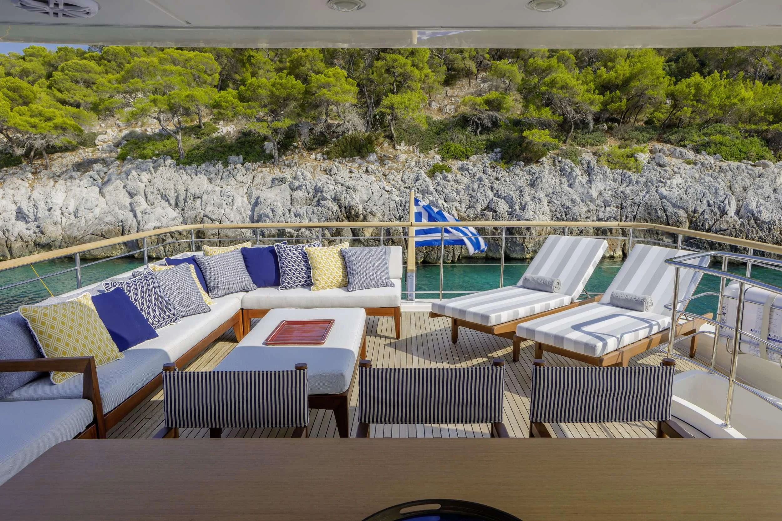 a deck with chairs and tables aboard ELYSIUM Yacht for Sale