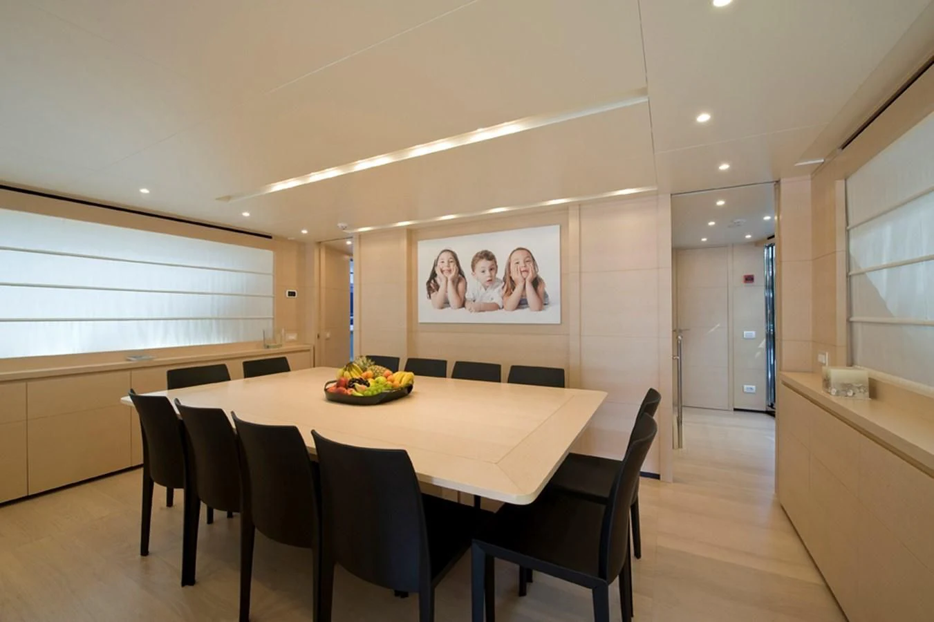 a dining table with chairs and a painting on the wall aboard ELYSIUM Yacht for Sale