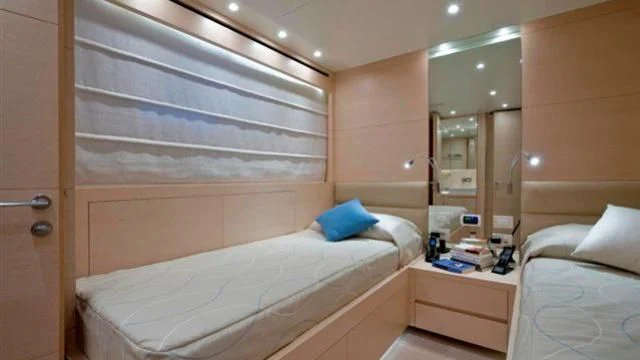 a room with a bed and a mirror aboard ELYSIUM Yacht for Sale