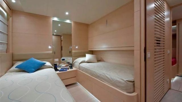 a room with a bed and a mirror aboard ELYSIUM Yacht for Sale