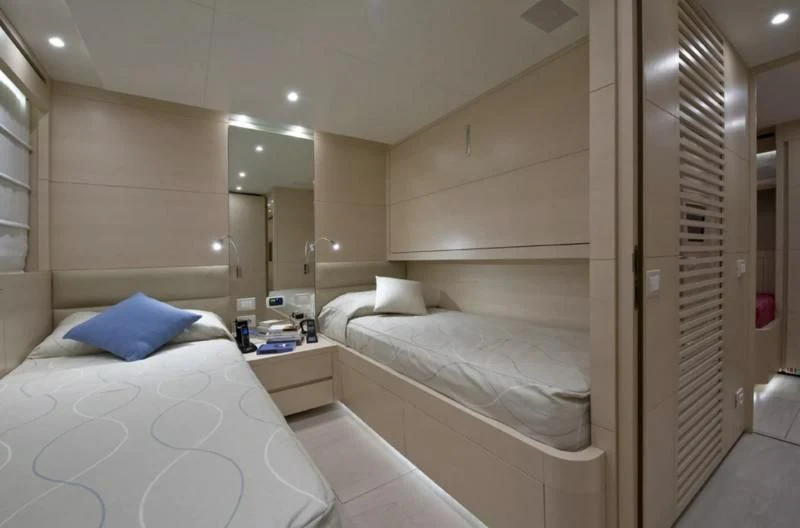 a room with a bed and a mirror aboard ELYSIUM Yacht for Sale