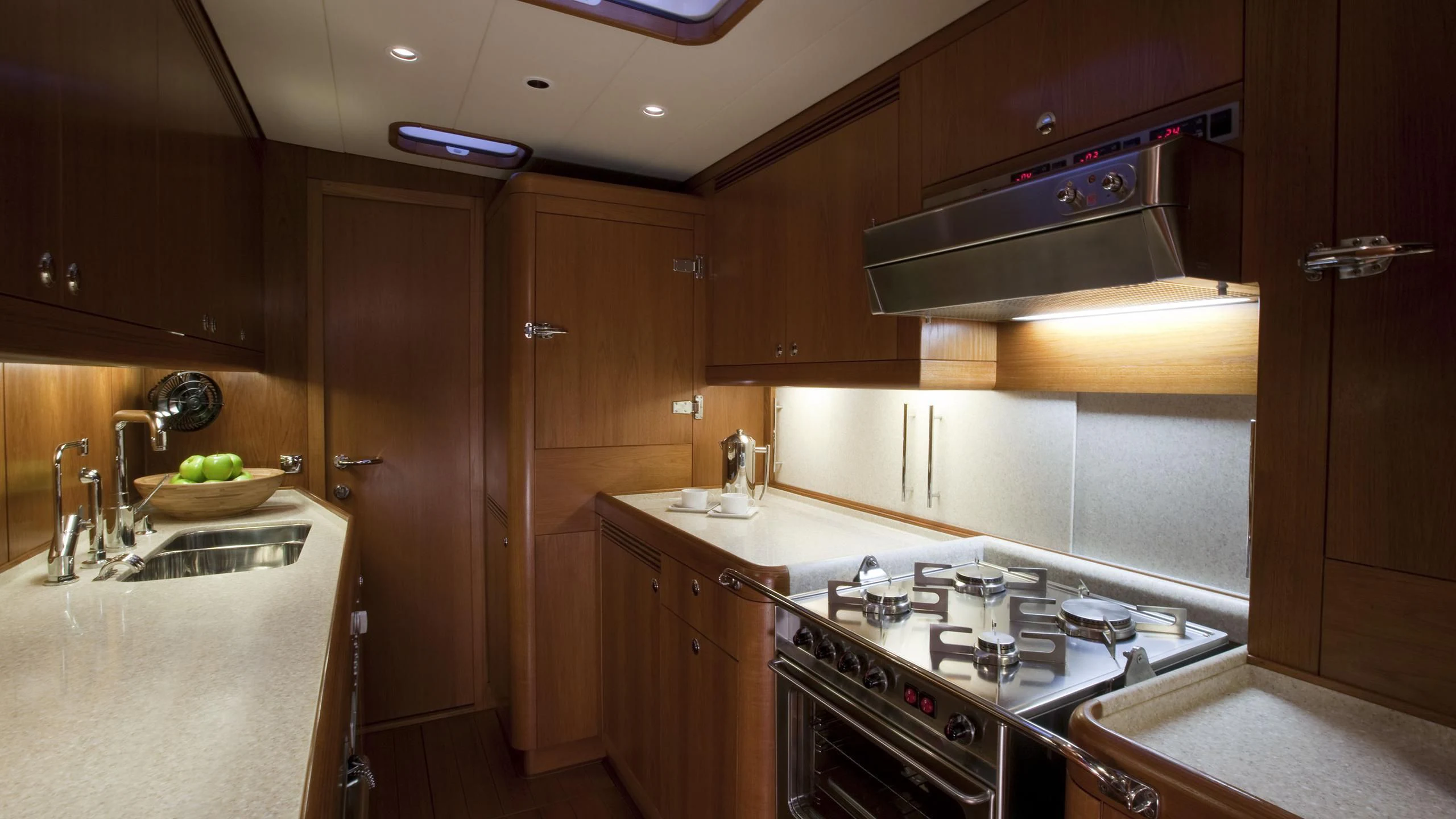a kitchen with wooden cabinets aboard ELYSIUM Yacht for Sale