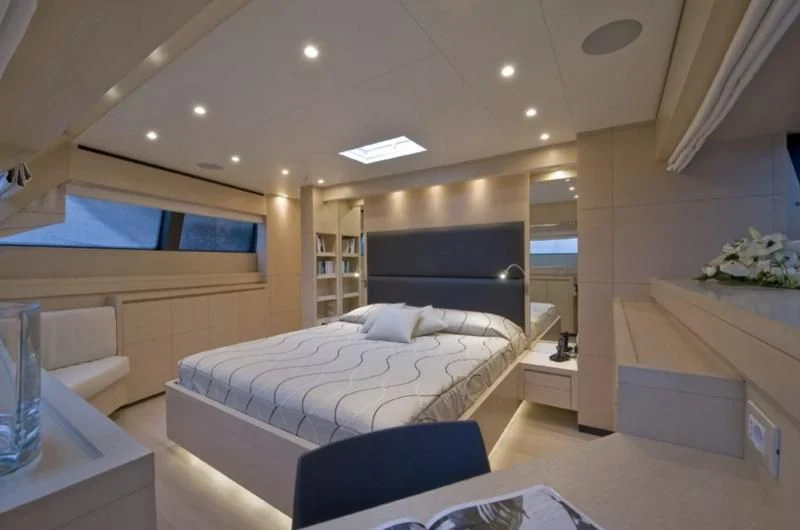a room with a bed and a desk aboard ELYSIUM Yacht for Sale