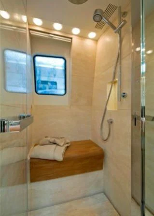a room with a bed and a window aboard ELYSIUM Yacht for Sale