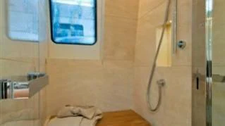 a room with a shower and a window aboard ELYSIUM Yacht for Sale