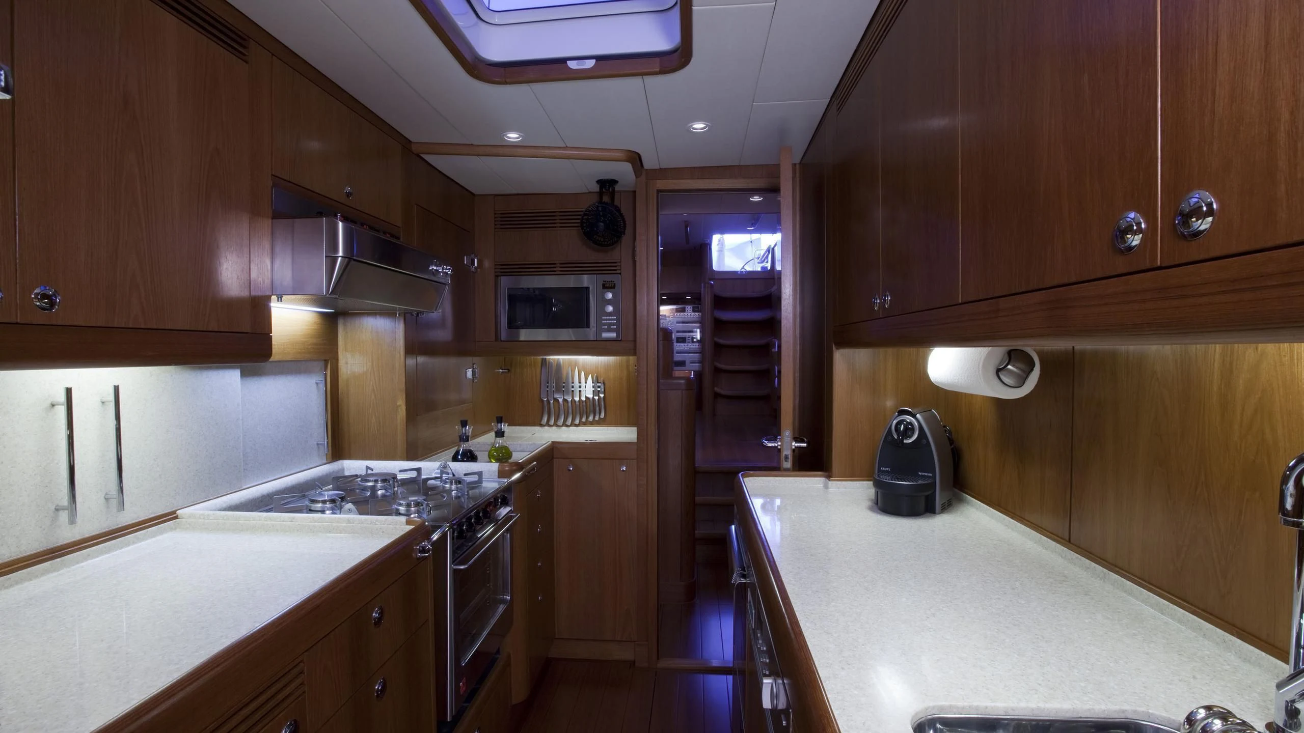 a kitchen with wooden cabinets aboard ELYSIUM Yacht for Sale