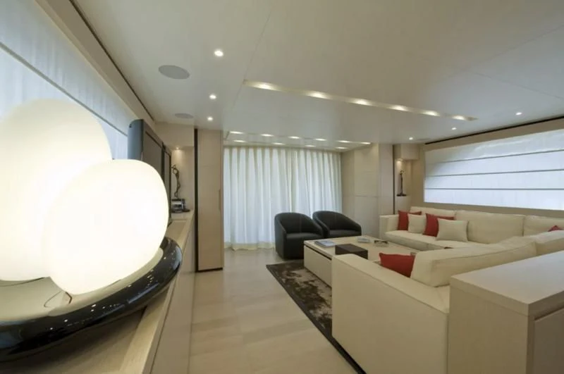 a room with a couch and a television aboard ELYSIUM Yacht for Sale