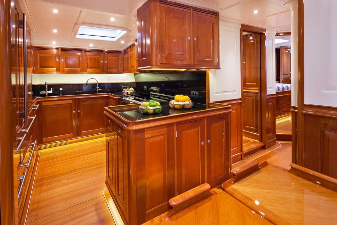a kitchen with wooden cabinets aboard ATALANTE Yacht for Sale