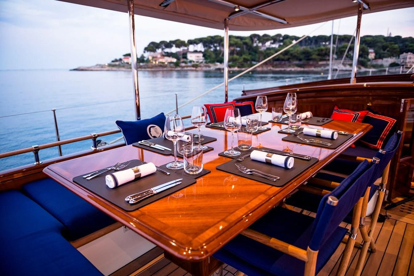 a table with wine glasses on it aboard ATALANTE Yacht for Sale