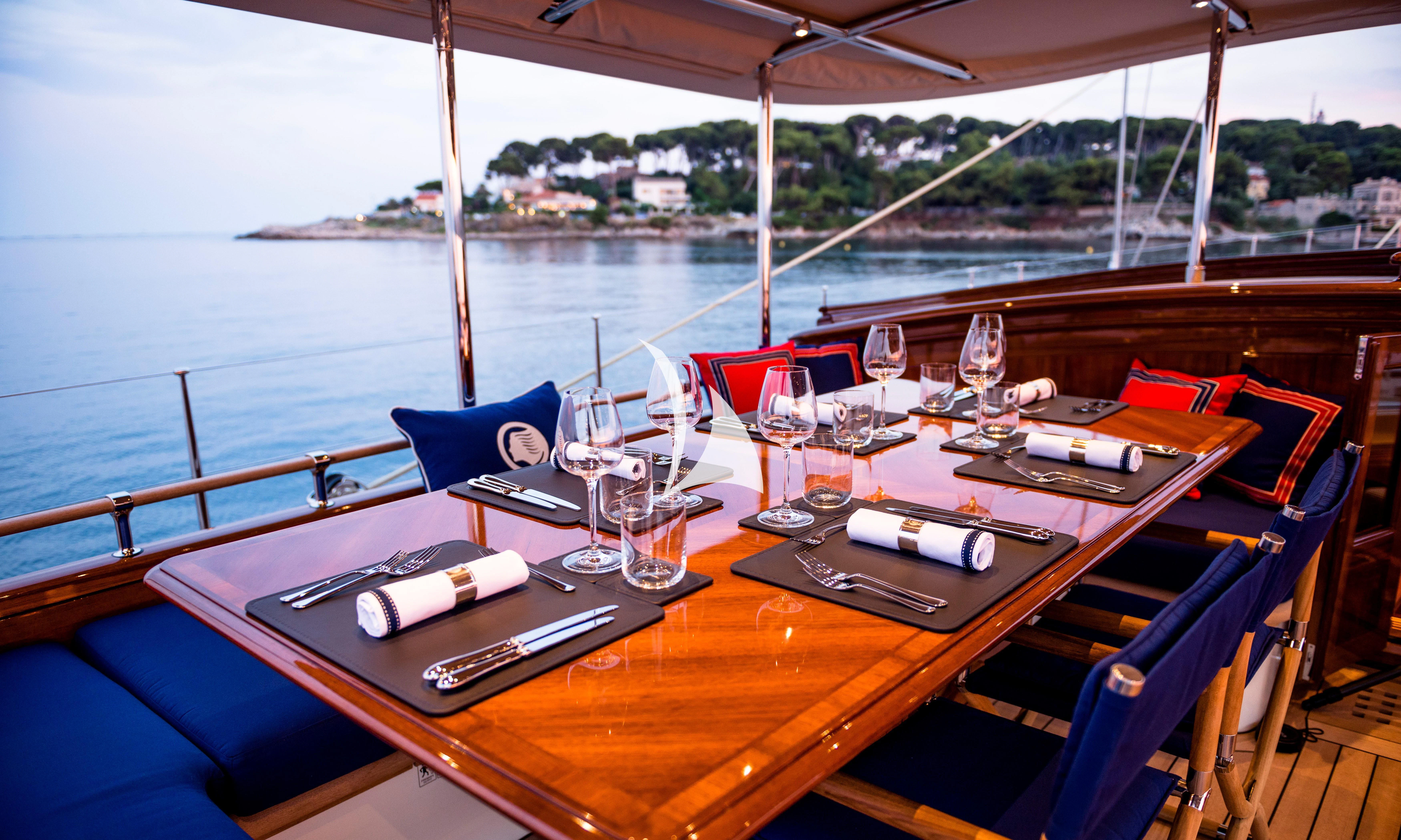 a table with wine glasses on it aboard ATALANTE Yacht for Sale