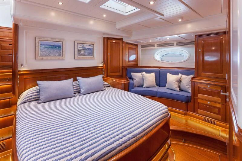 a bedroom with a bed and a wood door aboard ATALANTE Yacht for Sale