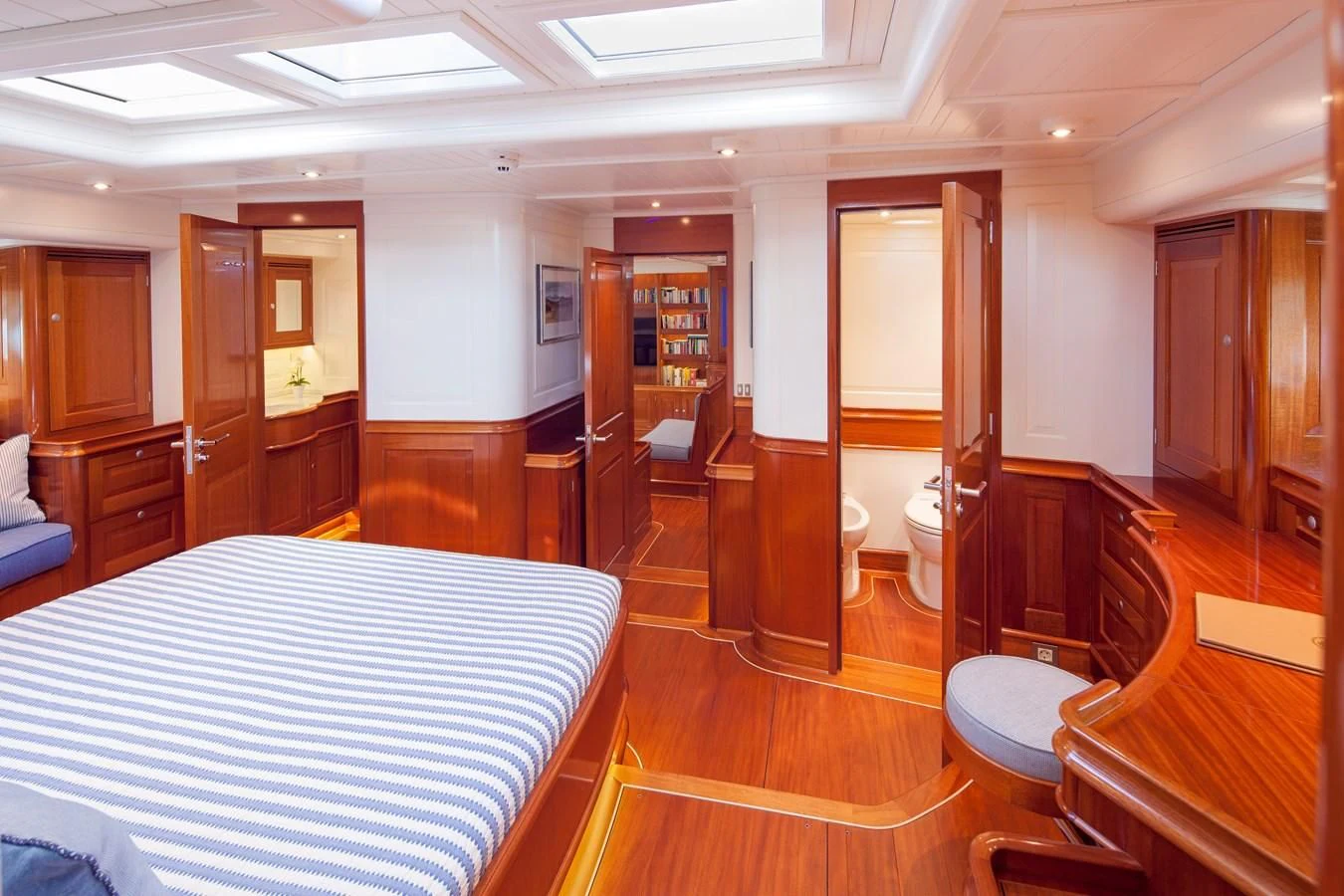 a room with a bed and a table aboard ATALANTE Yacht for Sale