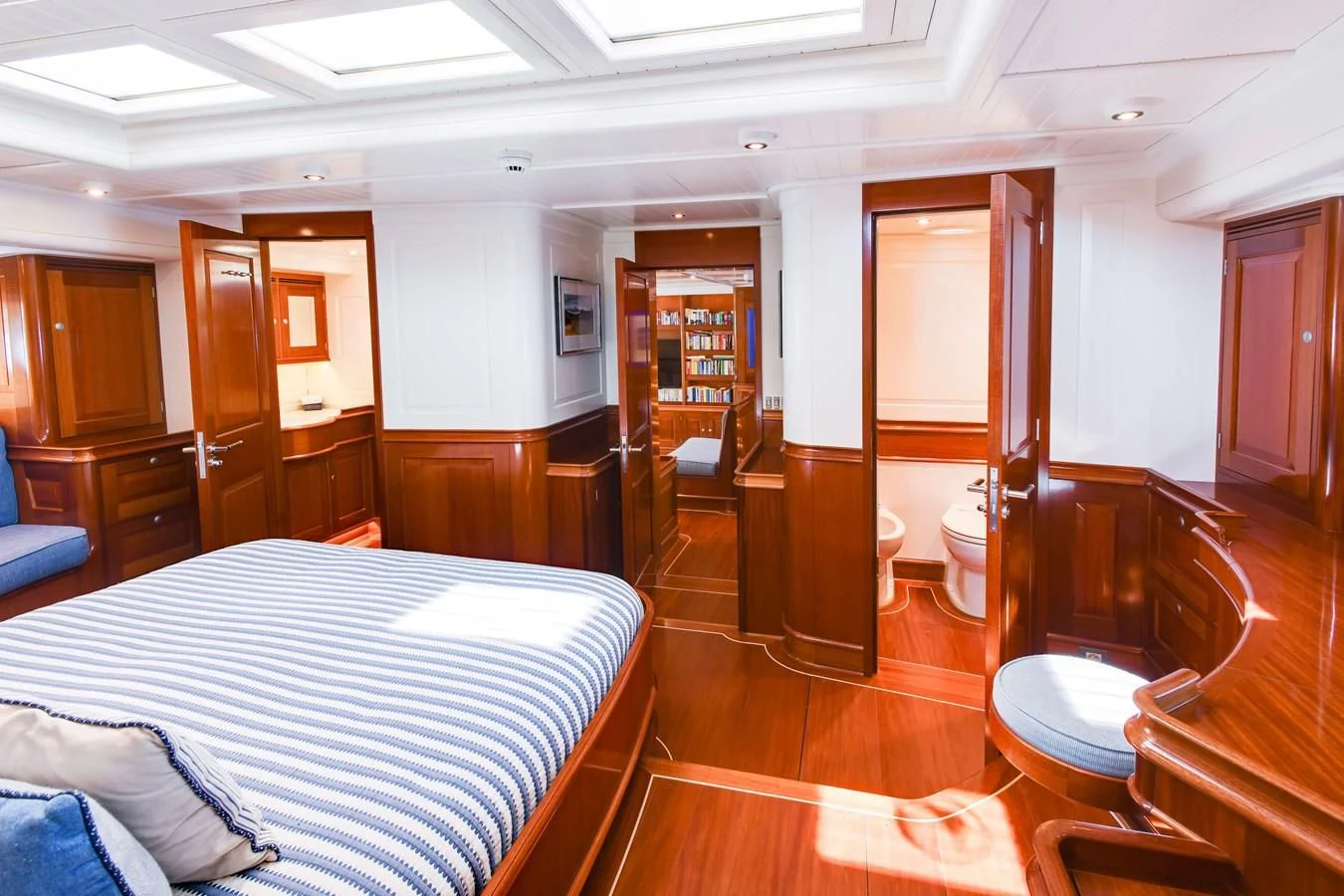 a bedroom with a bed and a hallway aboard ATALANTE Yacht for Sale