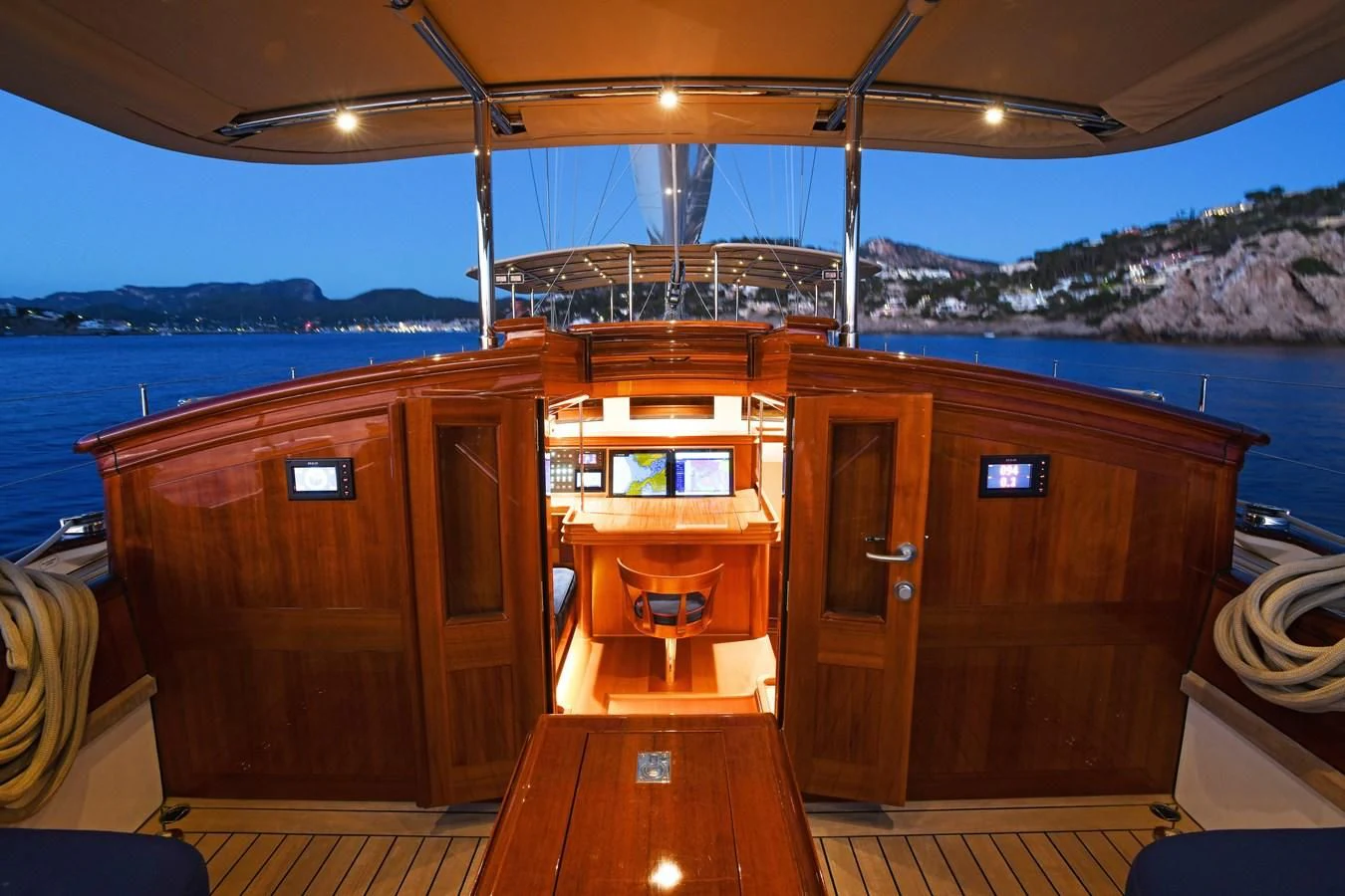 a cabin with a view of the ocean and a city in the background aboard ATALANTE Yacht for Sale