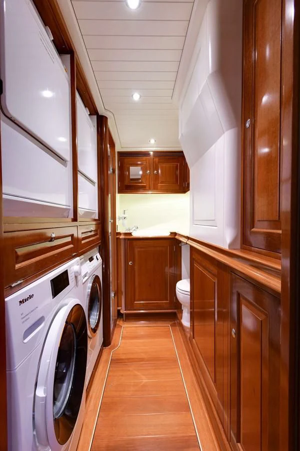 a kitchen with wooden cabinets aboard ATALANTE Yacht for Sale