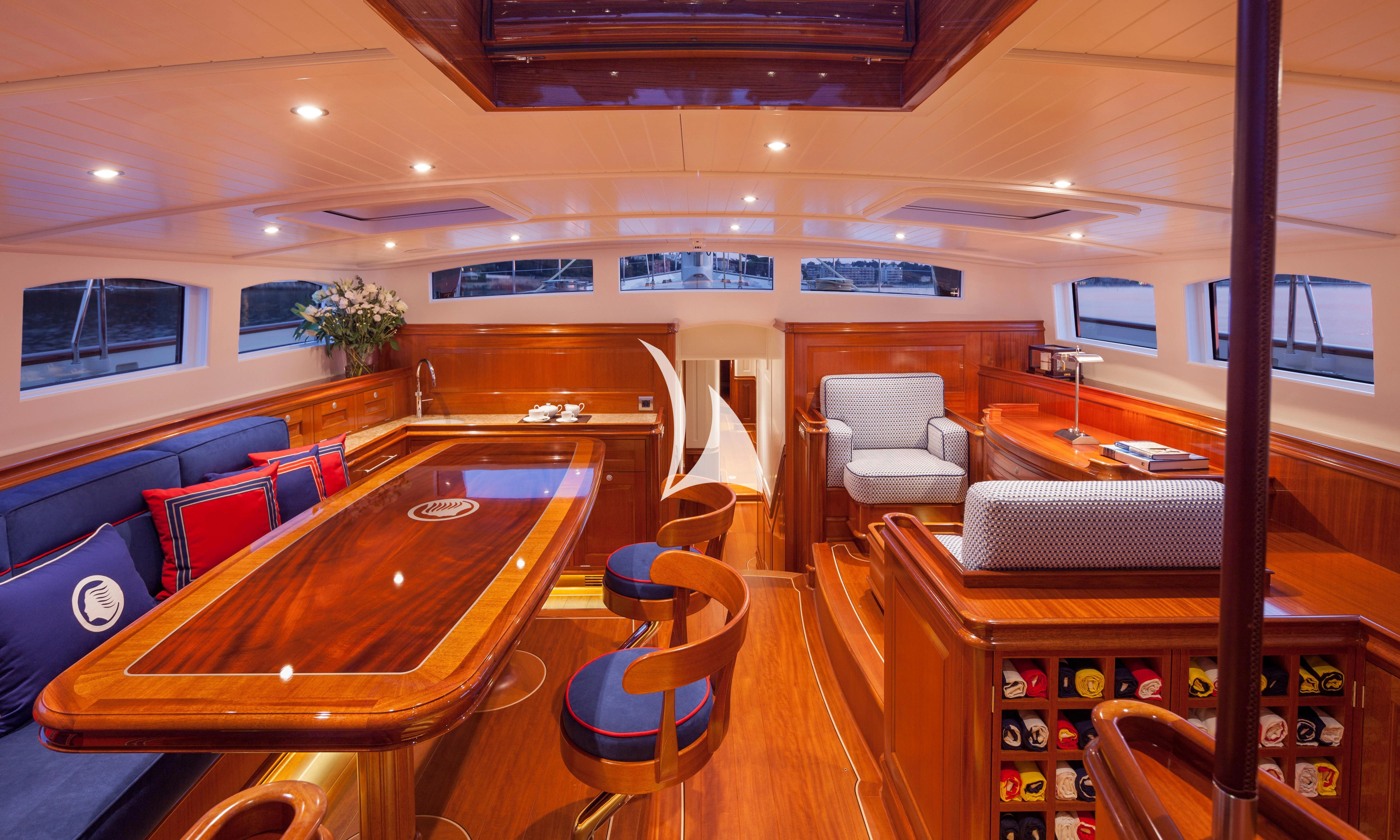 a room with a table chairs and a tv aboard ATALANTE Yacht for Sale