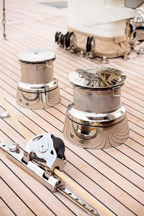 a group of metal objects on a wooden surface aboard ATALANTE Yacht for Sale