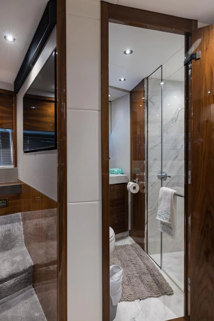 a bathroom with a glass shower aboard MR. G Yacht for Sale