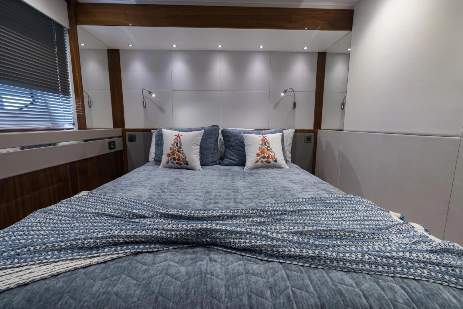 a bed with a blue comforter aboard MR. G Yacht for Sale