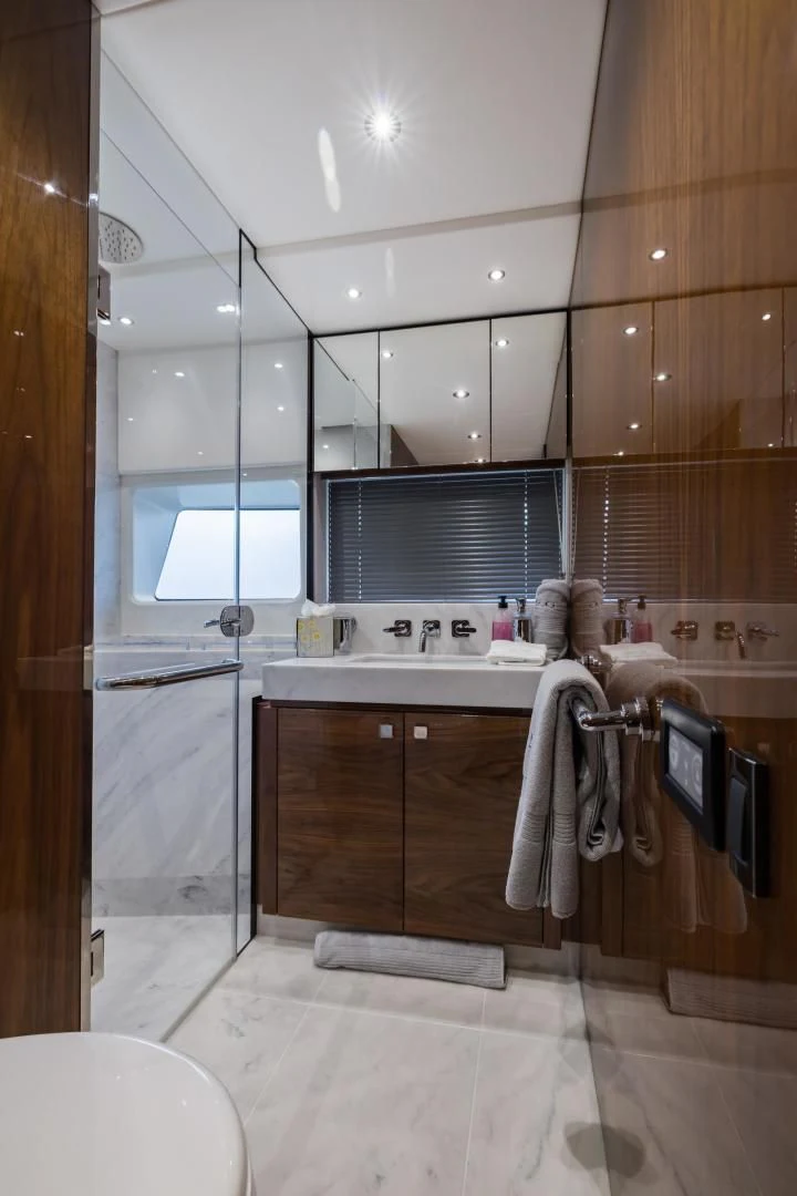 a bathroom with wooden cabinets aboard MR. G Yacht for Sale