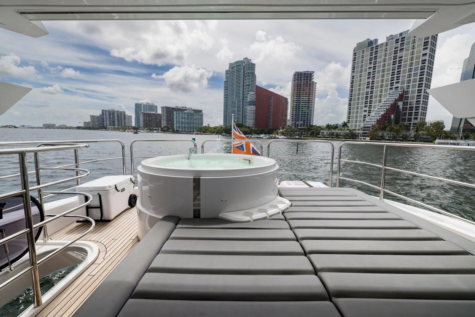 a deck with a view of a city and a body of water aboard MR. G Yacht for Sale