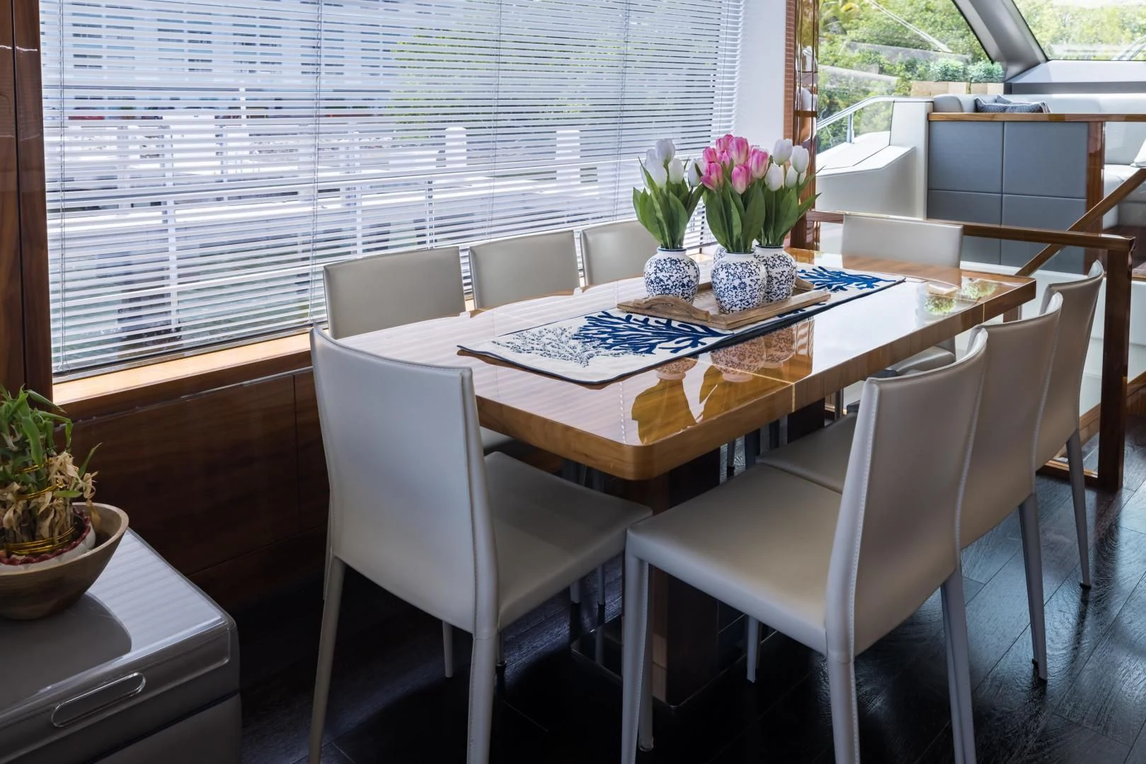 a table with chairs and a plant on it aboard MR. G Yacht for Sale