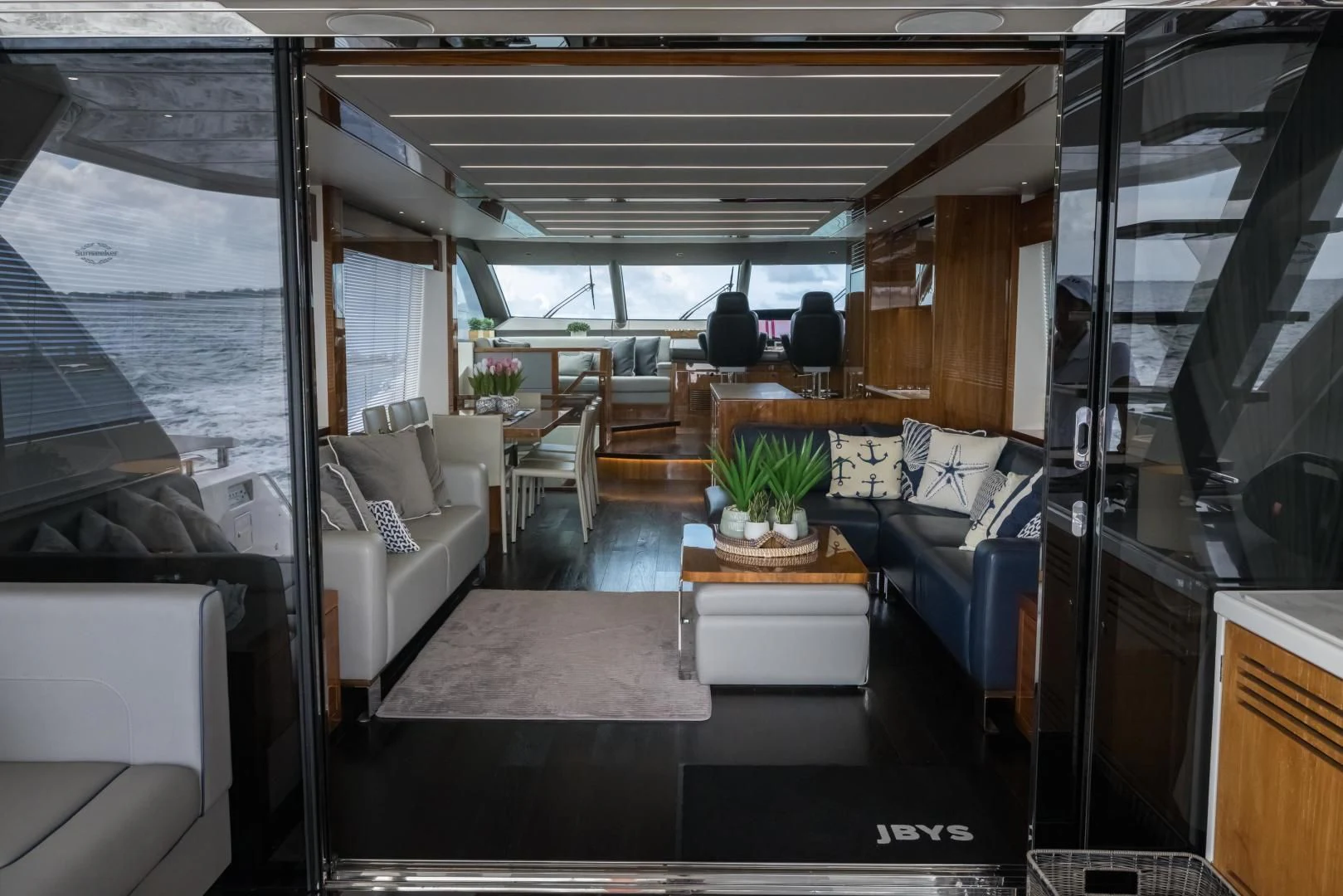 a room with a table and couches aboard MR. G Yacht for Sale