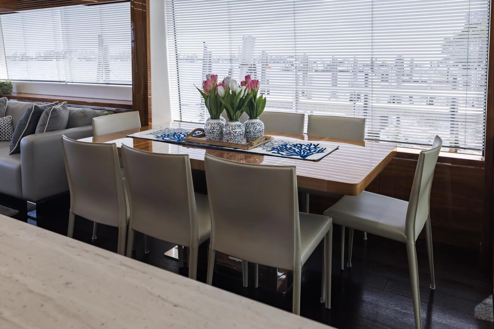 a dining table with chairs and a couch in the background aboard MR. G Yacht for Sale