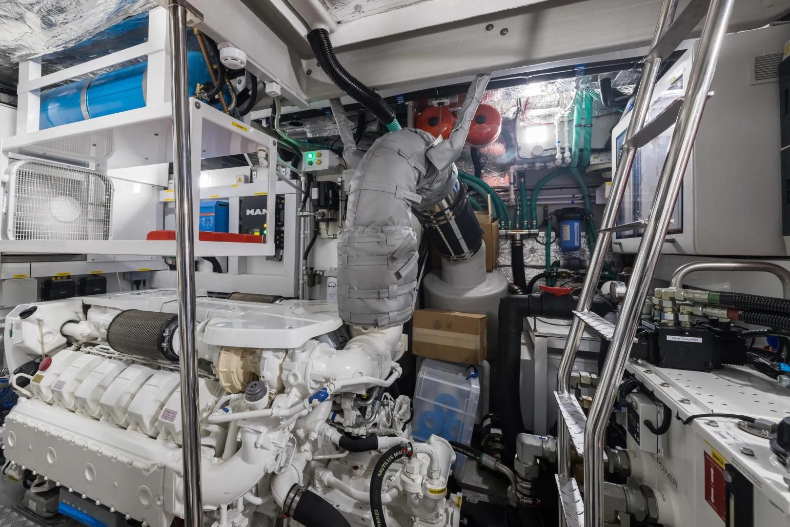 a person in a grey suit in a room with white machines aboard MR. G Yacht for Sale