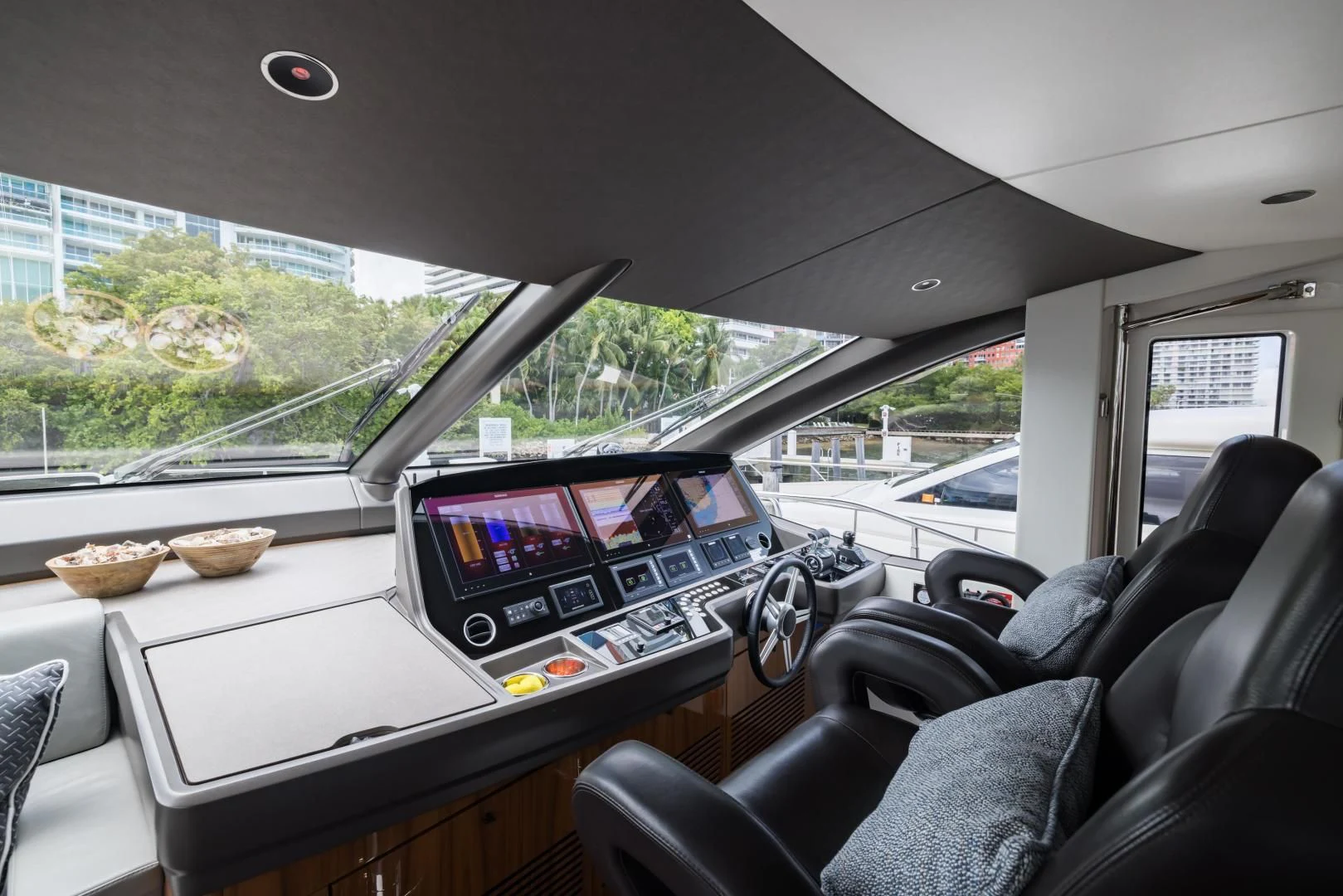 inside of a car with a laptop and a tray of food aboard MR. G Yacht for Sale