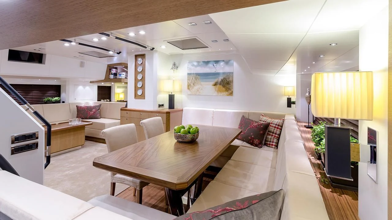 a living room with a table and couches aboard BELLKARA Yacht for Charter