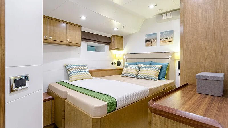 a bedroom with a bed and a wood floor aboard BELLKARA Yacht for Charter