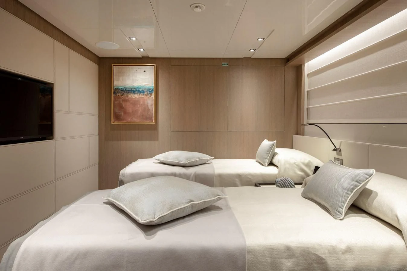 a room with a bed and a television aboard INSIEME Yacht for Sale