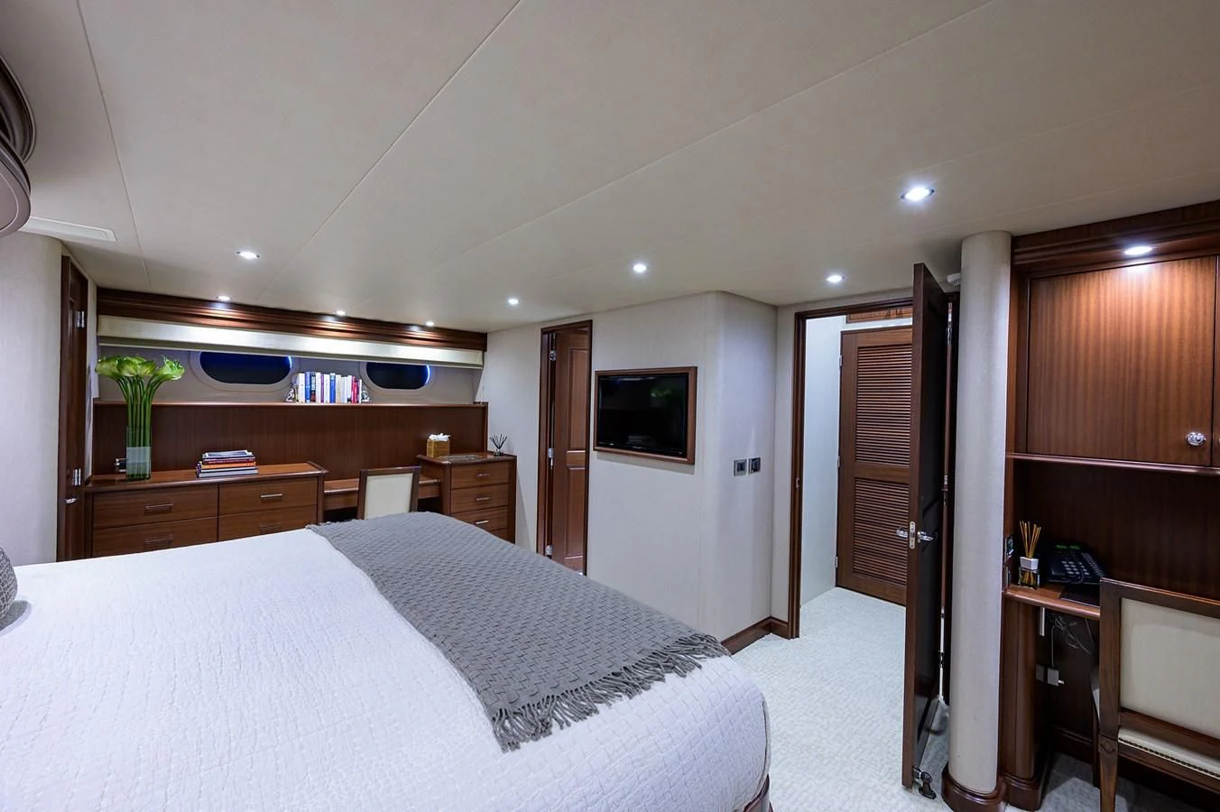 a bedroom with a bed and a television aboard ROBINSON CRUSOE Yacht for Sale