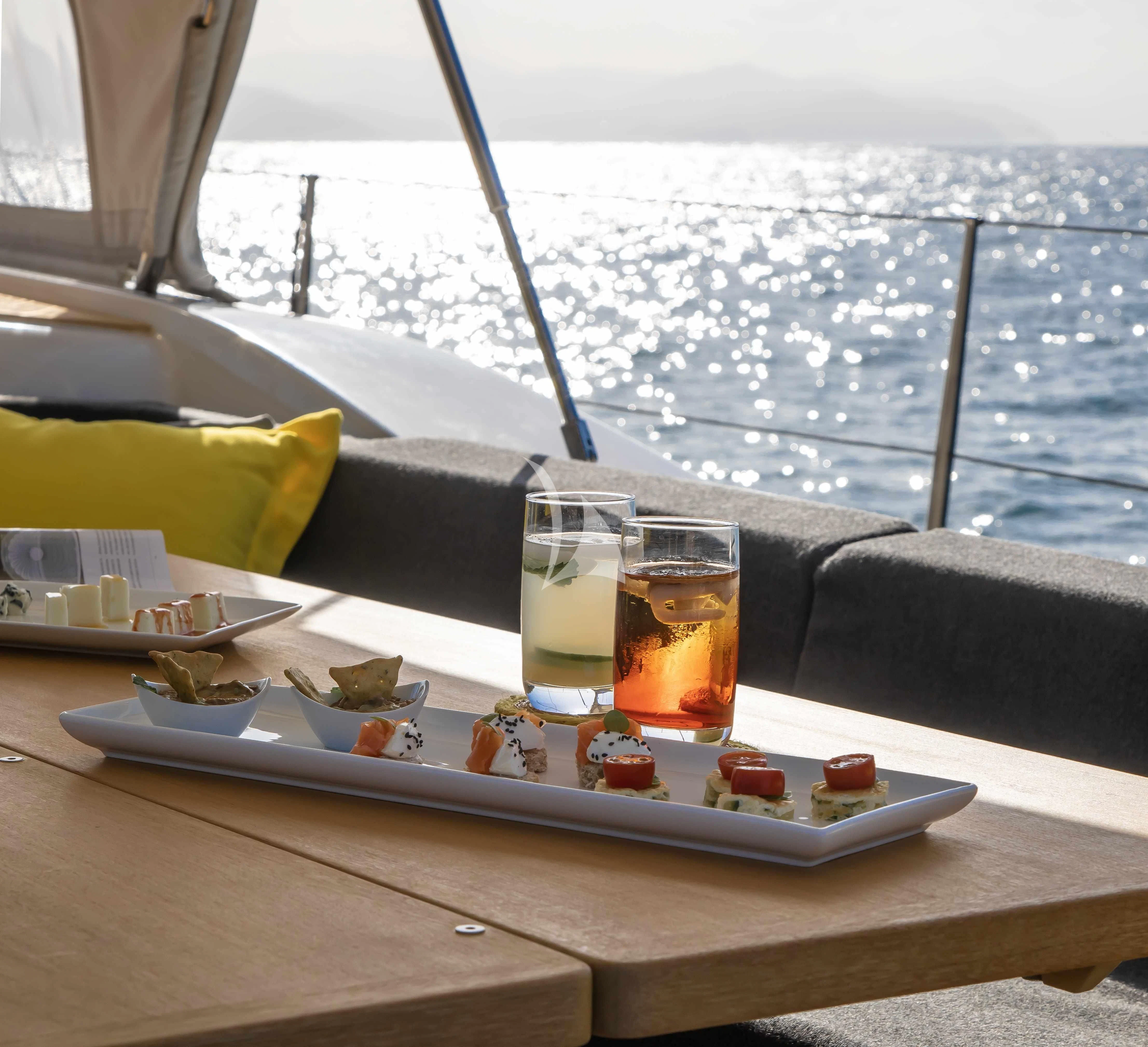 a tray of food and glasses on a boat aboard AMMONITE Yacht for Charter