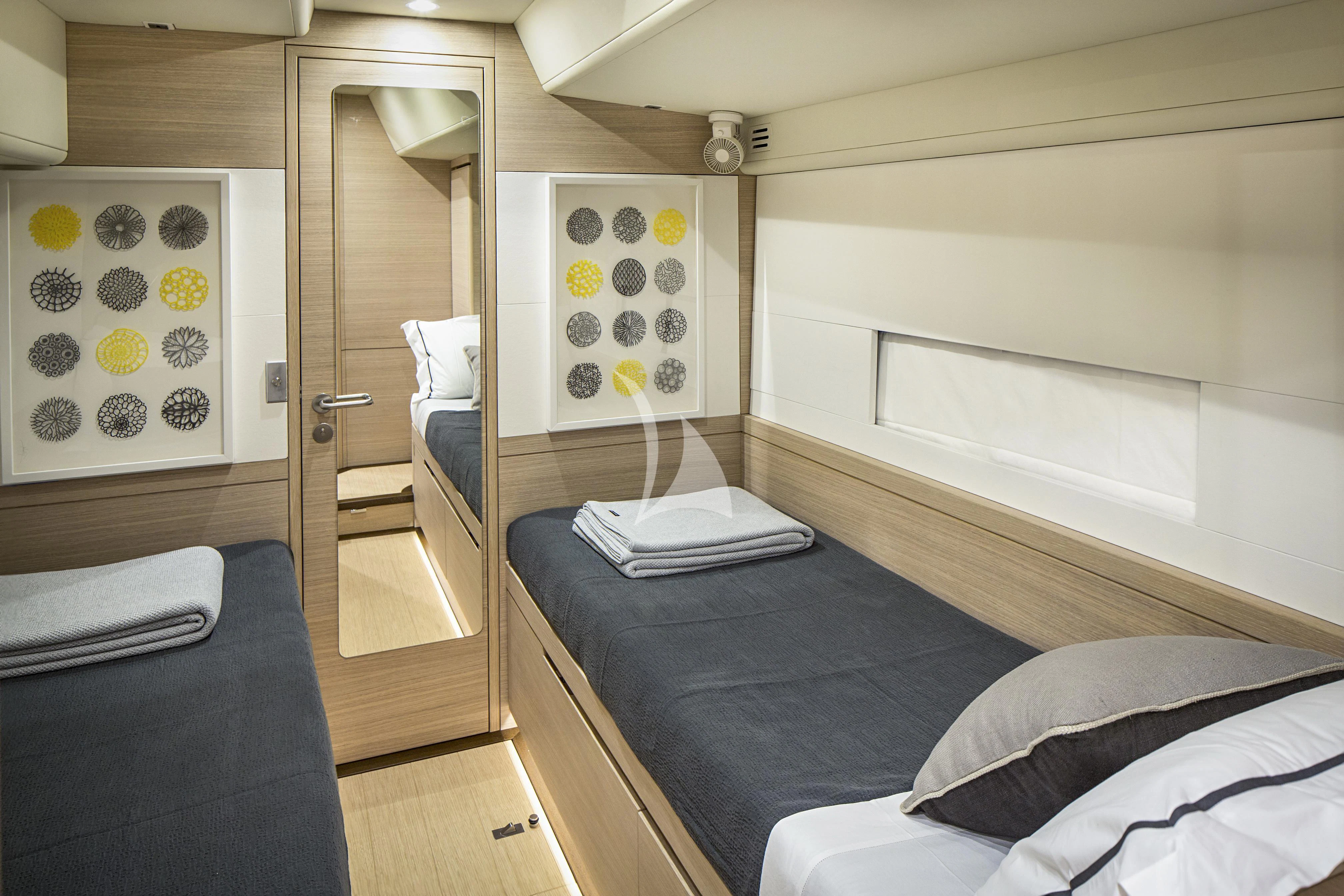 a bedroom with a bed and a closet aboard AMMONITE Yacht for Charter