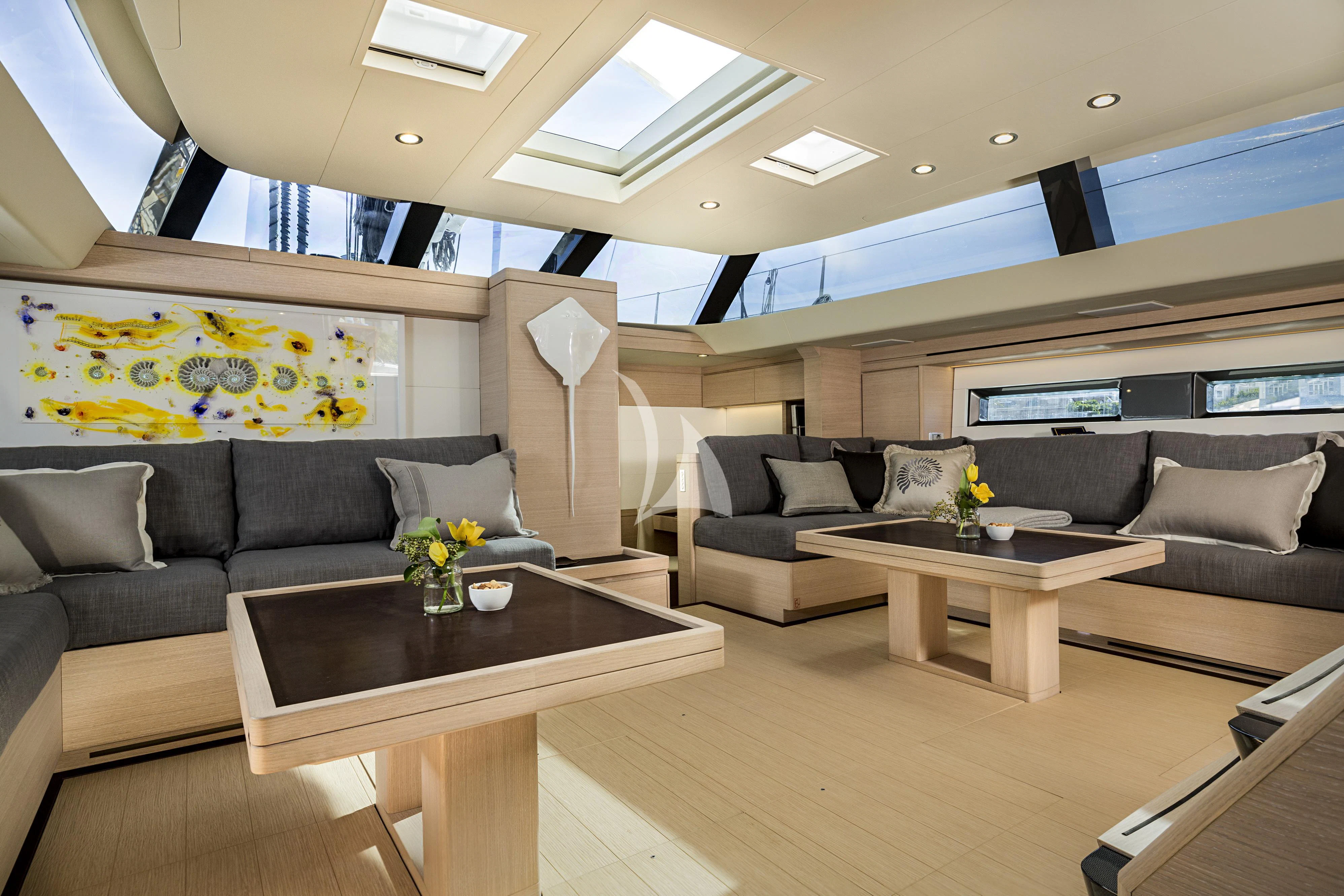 a living room with a couch and a coffee table aboard AMMONITE Yacht for Charter