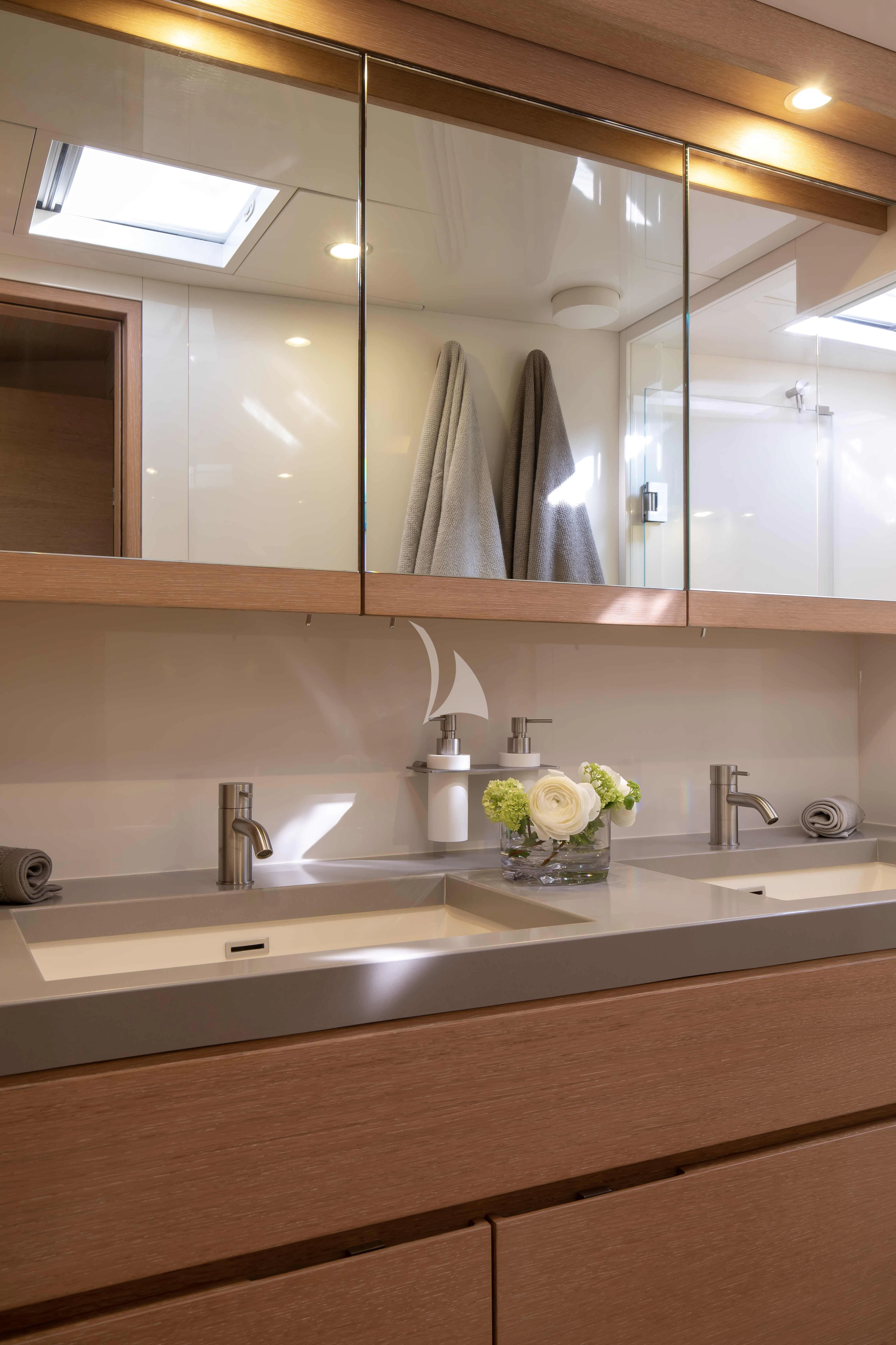 a bathroom with a large mirror aboard AMMONITE Yacht for Charter
