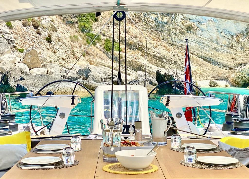 a table with plates and glasses on it aboard AMMONITE Yacht for Charter