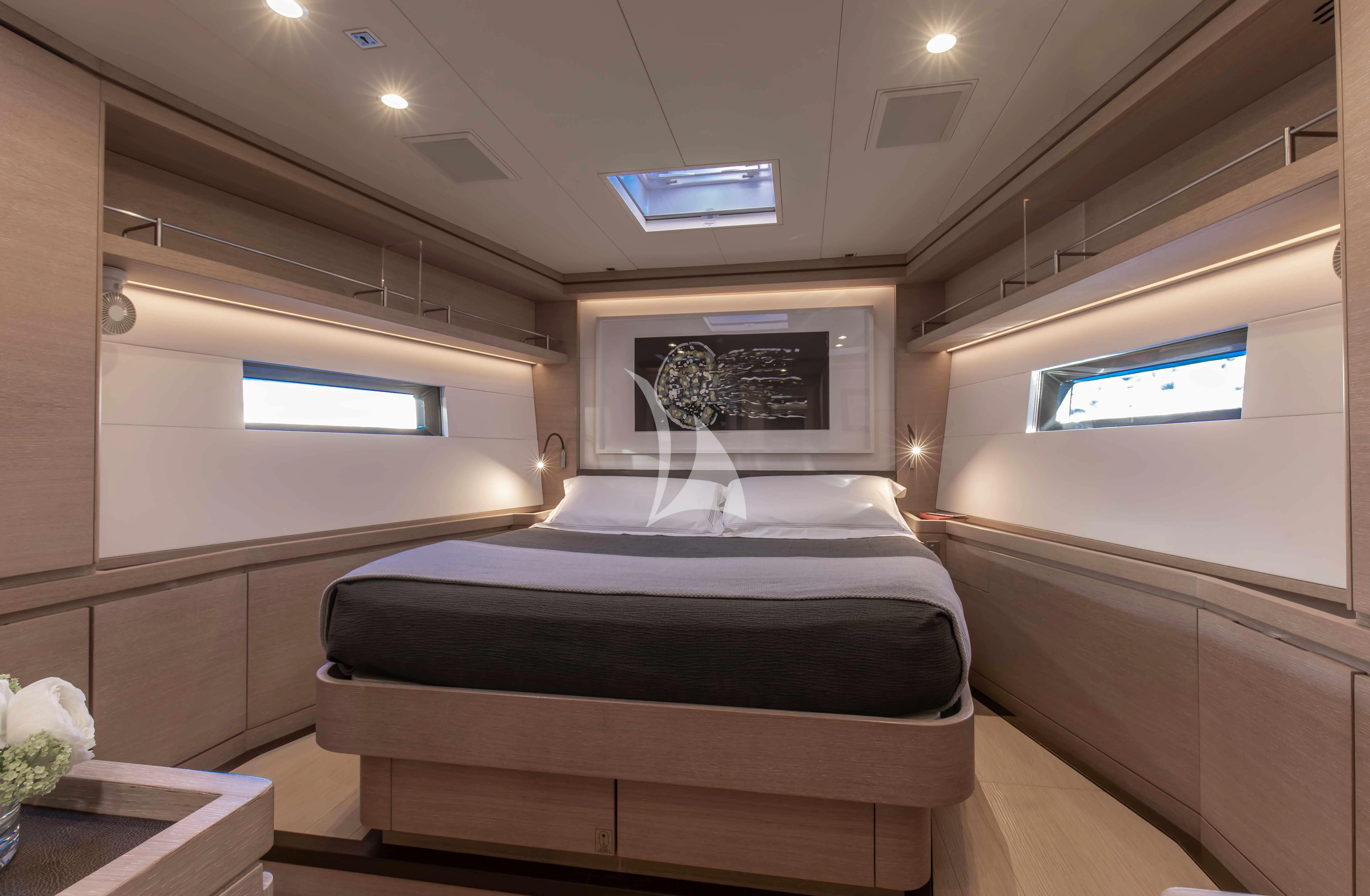 a room with a bed and a window aboard AMMONITE Yacht for Charter