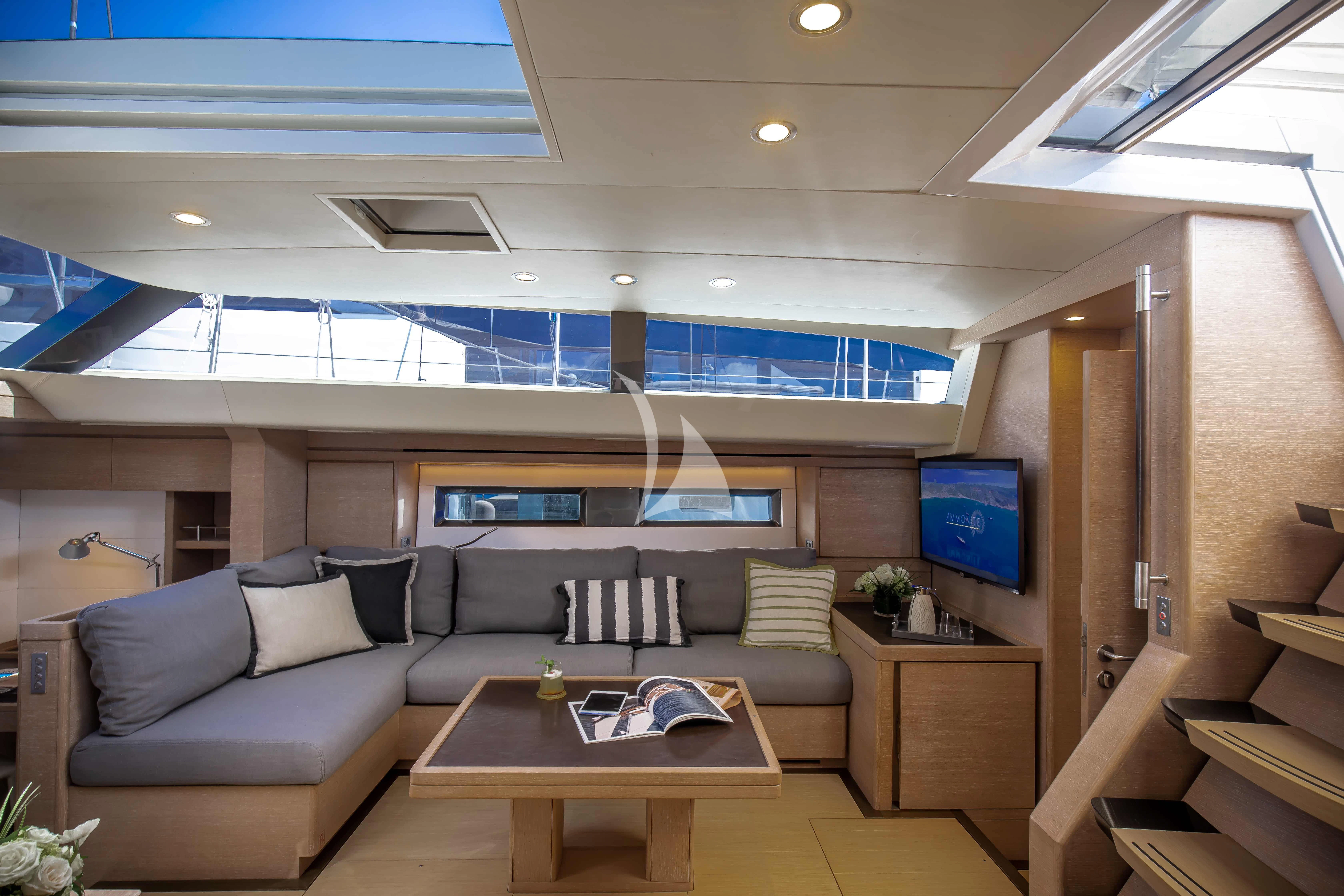 a living room with a couch and a coffee table aboard AMMONITE Yacht for Charter