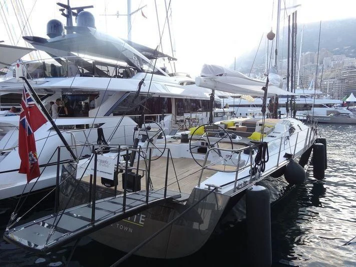 a boat with a flag on it aboard AMMONITE Yacht for Charter