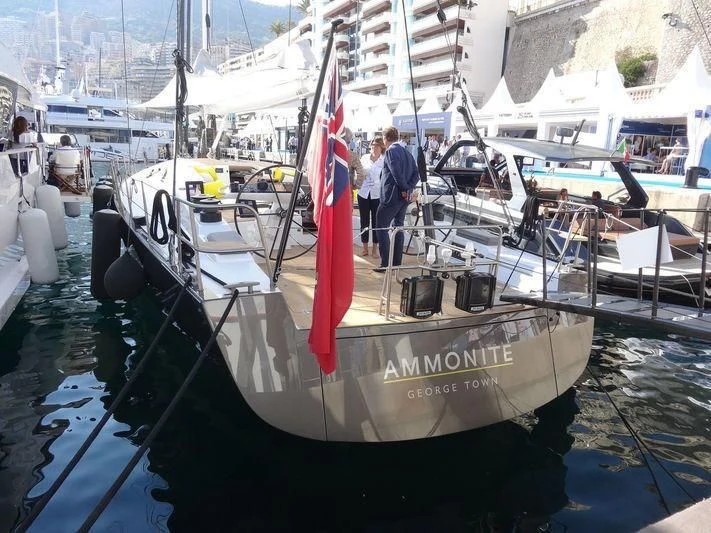 a boat with a red and white flag on it aboard AMMONITE Yacht for Charter